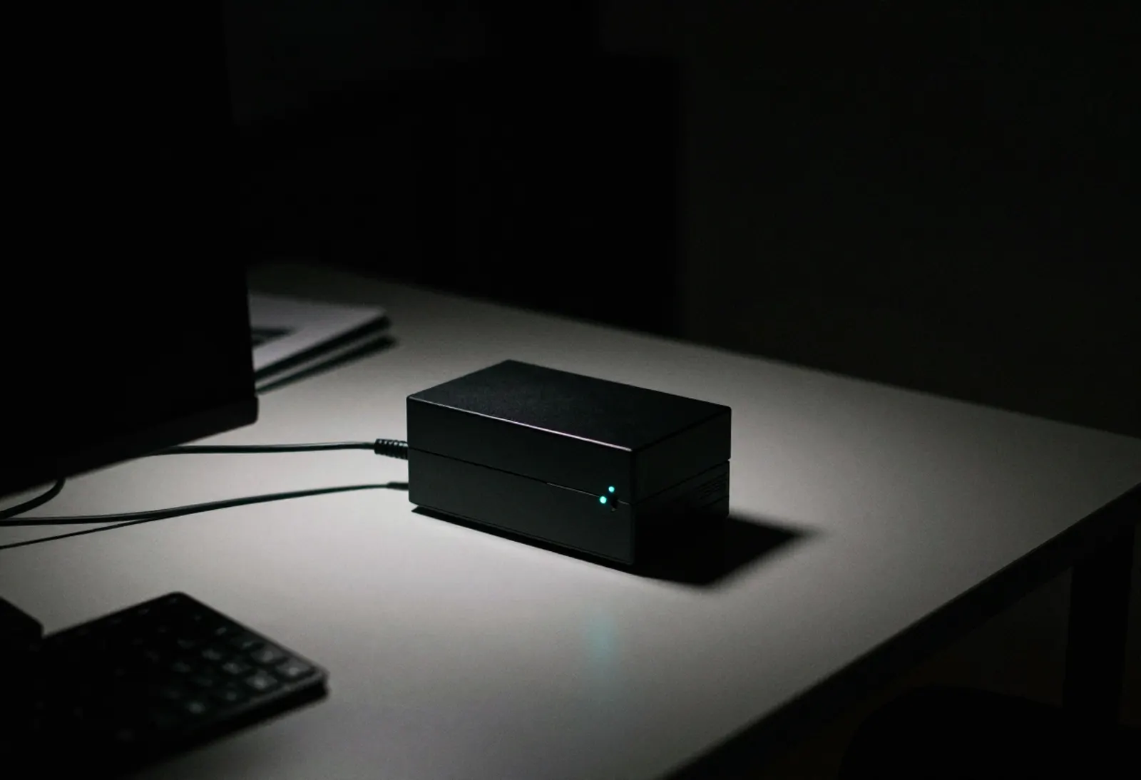 Lioom's AI machine on a desk in the dark.